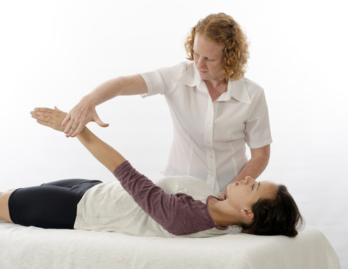 Practitioner using a muscle test on a client